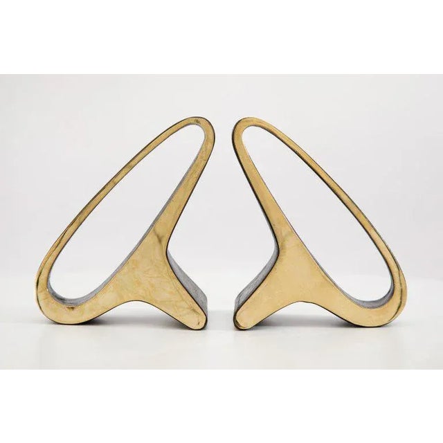 Pair of Carl Auböck model #3848 brass bookends. Designed in the 1950s, this incredibly refined and sculptural pair of...