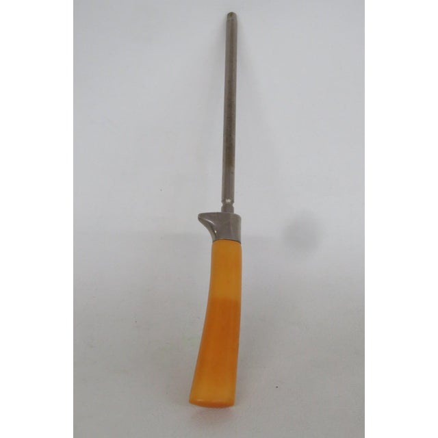This lovely Knife Sharpener Rod is made out of steel and bakelite. It features a classically Mid-Century Modern style with...