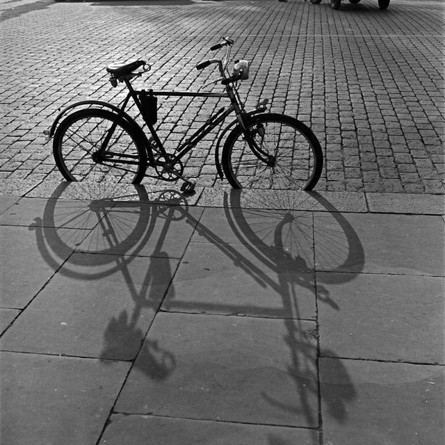 The photographer's note regarding this work is "A bicycle with its shadow in the autumn sun, Germany 1930s." This work...