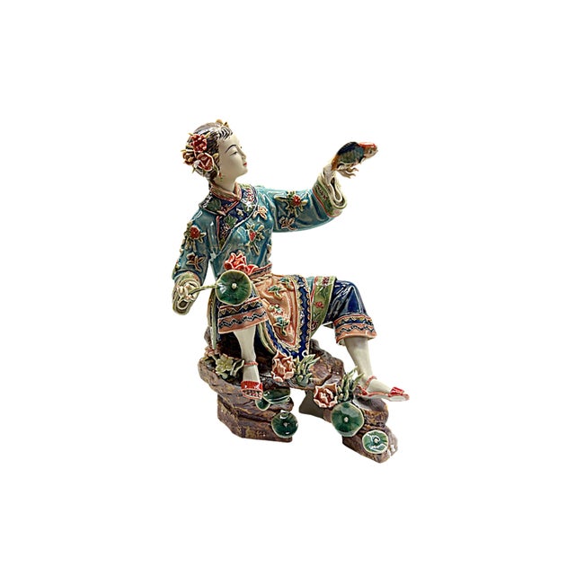 Capture the elegant beauty and exquisite detail of this hand-painted porcelain figurine. This stunning piece depicts a...