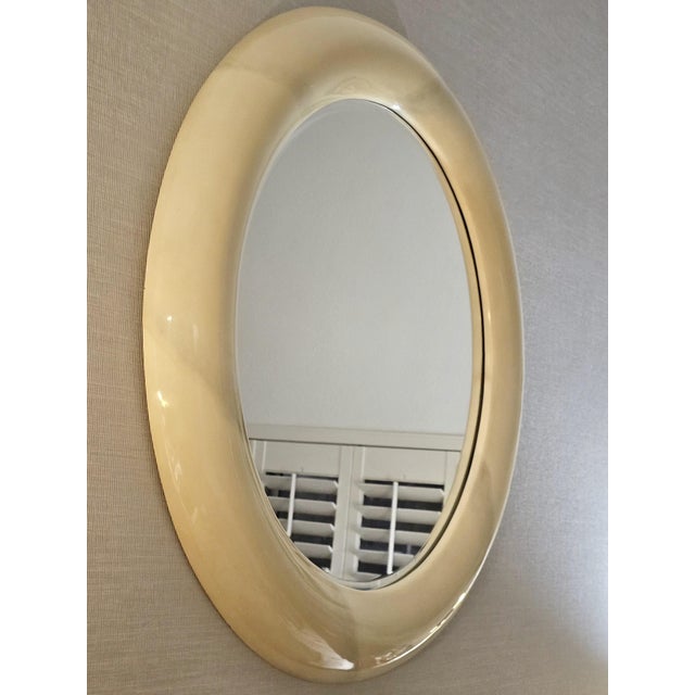 An elegant vintage 1970s round wall mirror featuring a generously proportioned, sculptural frame finished in lustrous...