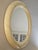 An elegant vintage 1970s round wall mirror featuring a generously proportioned, sculptural frame finished in lustrous...