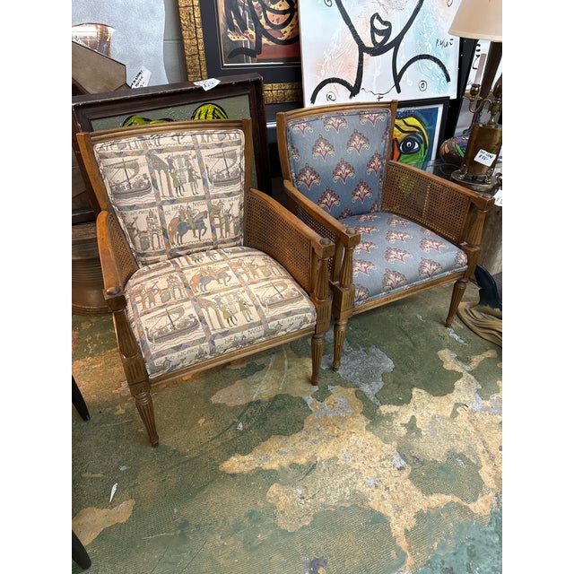 Fantastic pair of regency style cane side lounge chairs. Newly reupholstered. Excellent ready to use condition