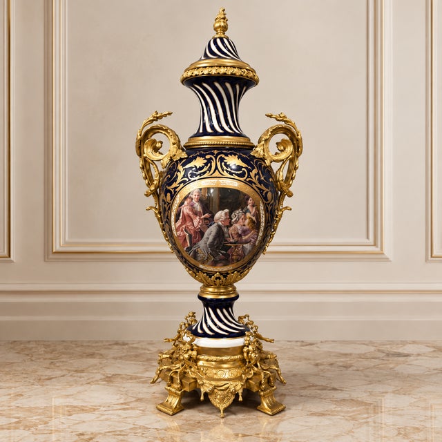 Make a striking statement with this ornate French-style decorative vase, featuring a rich navy blue and white porcelain...