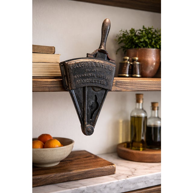 This authentic English Follows & Bate marmalade cutter features its original cast iron body and turned wood handle,...