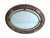 This refined oval wall mirror features a finely carved wooden frame with floral motifs and Baroque-style scrolls. The...