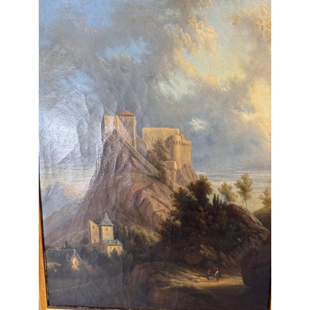 This exquisite antique oil painting captures a breathtaking European landscape featuring a grand medieval castle atop a...