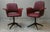 Gorgeous 1960s armchairs, fully restored with burgundy red upholstery and brass studs. These chairs feature a delicate...