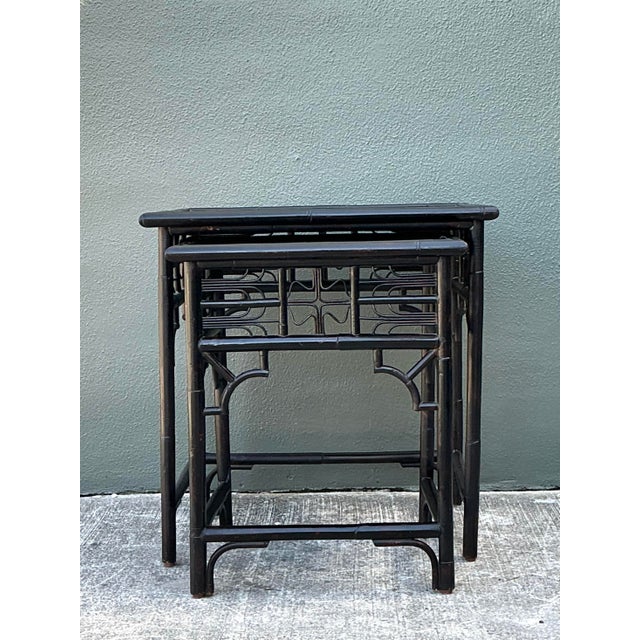 This exquisite set of two vintage nesting tables is a masterclass in Hollywood Regency design, showcasing a sophisticated...