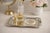 A beautifully detailed vintage Sheridan silverplate tray featuring ornate mid‑century scroll engraving and a softly...