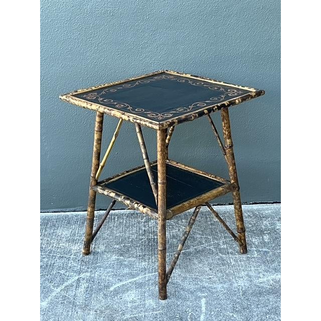 This stunning vintage side table is an elegant interpretation of British Colonial design, featuring a classic bamboo frame...