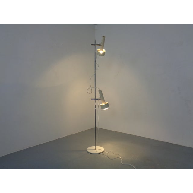 A minimalist floor lamp by Edi Franz for Swiss Lamps International from the 1960s, adjustable in angle and height. Both...