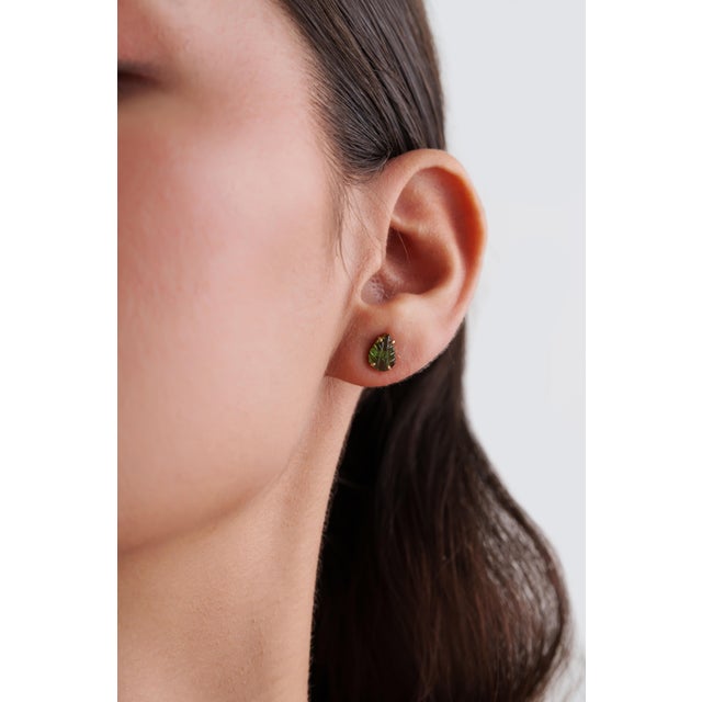 These elegant stud earrings feature a 1.60 ct carved green tourmaline, set in 14k yellow gold. Each measuring 8 × 5.5 mm...