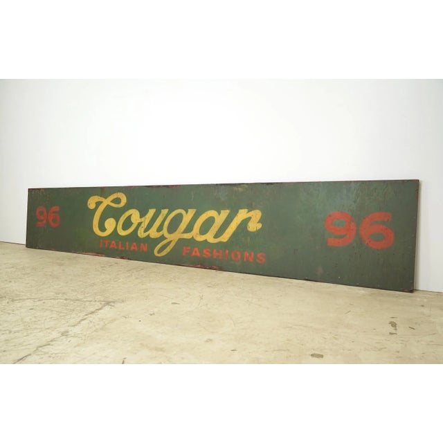 Reclaimed movie set sign made of aluminum in a yellow, red, and green color. The sign reads "96, Cougar, Italian...