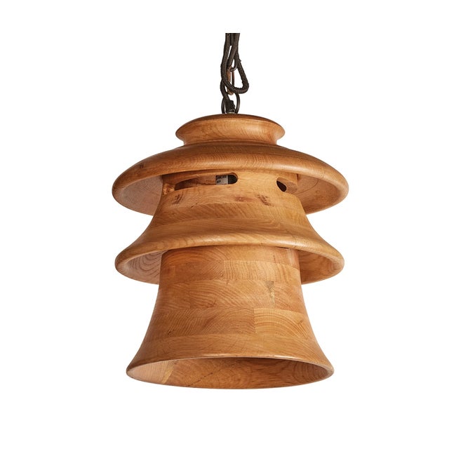 The Oak Wood Tiered Pendant is crafted in the shape of 1970s-era insulator caps found on the tops of electric poles. This...