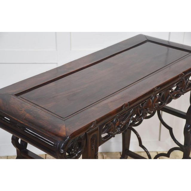 A beautiful antique Chinese altar table, finely crafted from rich hardwood with a deep, polished finish. The rectangular...