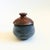 A vintage handmade studio pottery lidded container. Finished in two toned glazes. The top is a reddish brown color and the...