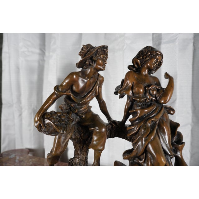 Capture the timeless charm of 19th-century European Romanticism with this beautifully modeled bronze figural sculpture...
