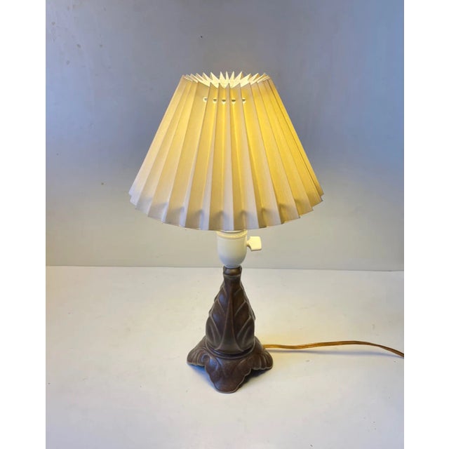 A small table lamp in glazed pottery from Søholm Stentøj. Stylistically it mimics the elongated organic lines and curves...