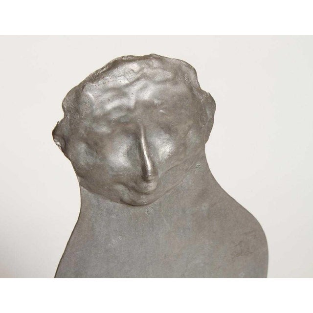 Mid-Century Modern cut steel sculpture depicting a man in bell bottom pants standing casually with a cigarette in his...
