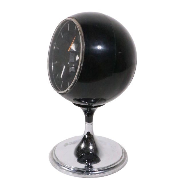 Iconic Space Age, Mid Century Bulova model 634 black ball clock, on chromed pedestal base. The clacok was made in Japan...