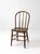 A vintage Windsor style bow back dining chair with a classic Early American silhouette, featuring a curved spindle back,...