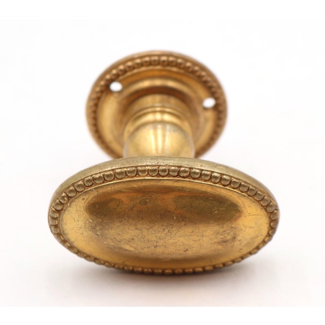 Traditional style oval shaped beaded closet door knob with a gold gilt finished bronze. The short spindle allows for a...