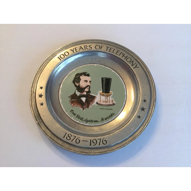 This ceramic plaque in set into a pewter plate made for the 1876-1976 celebration of the Bell System. Which no longer...