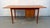 A beautifully crafted Mid-Century Modern teak drop-leaf desk designed by renowned Danish designer Arne Vodder for H. Sigh...