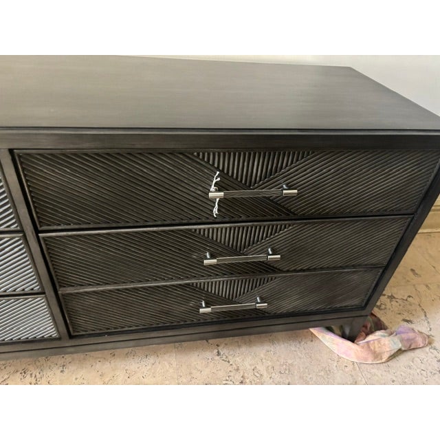 Elevate any space with this sophisticated Vanguard three-drawer console, featuring a rich charcoal finish and beautifully...