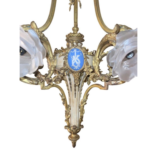 An exceptional 19th-century French gilt bronze chandelier, richly detailed and distinguished by its marble central body...