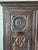 Striking antique three-door cabinet featuring exceptional hand-carved craftsmanship throughout. The façade showcases bold...