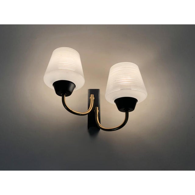 Pair of Vintage House Wall Applies Arlus 1950s in brass, glass globe. Superb pair of brass wall lights with glass globe,...