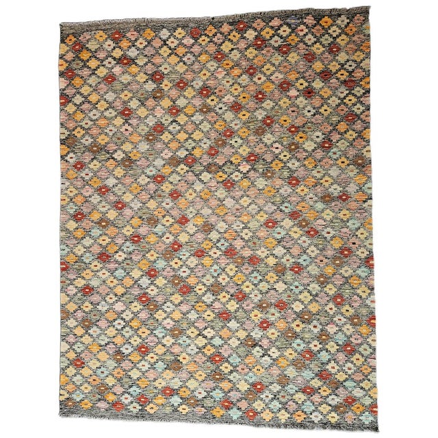 Handcrafted Contemporary Kilim with Geometric and Floral Motifs This contemporary kilim rug interprets textile tradition...