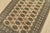 A tribal Bokhara rug hand-knotted with fine wool on a cotton foundation. This rug features rows of repeating medallions...