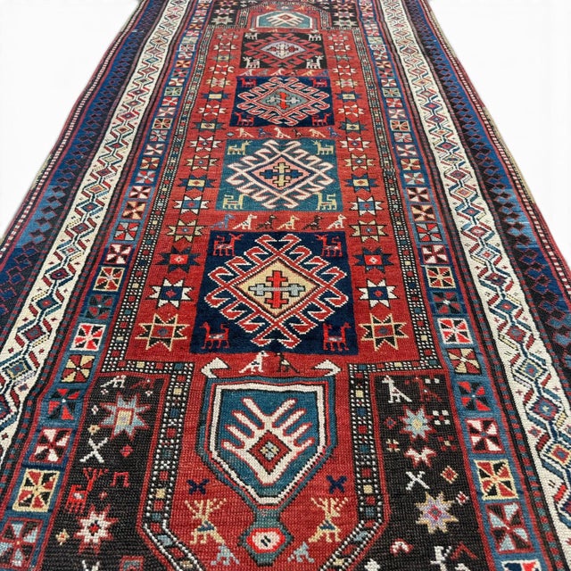 This exceptional antique Kazak runner, approximately 120 years old, is a rare example of highly detailed Caucasian...
