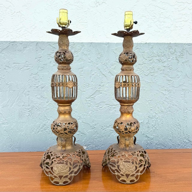 A stunning pair of vintage chinoiserie-inspired table lamps, exquisitely crafted with ornate gold gilt metalwork and...