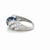 This beautifully classic ring by Tiffany & Co. in an elegant swirl design, boasts seven bright blue round brilliant cut...