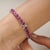A classic ruby eternity-style tennis bracelet crafted in 925 sterling silver, defined by its continuous line of color and...