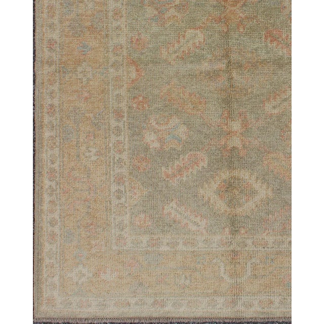 Measures: 4'0 x 5'3. Turkish Oushak Rug in Soft Sage Green, Muted Terracotta, and Faded Blue Accents. Keivan Woven Arts /...