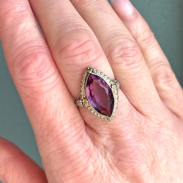 A vision of regal splendor, captured in gold and stone. This exquisite marquise-cut amethyst glows with the deep, velvety...