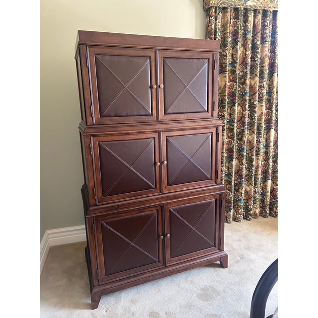 A rare and sophisticated entertainment cabinet by Bernhardt, masterfully crafted from rich mahogany and accented with...