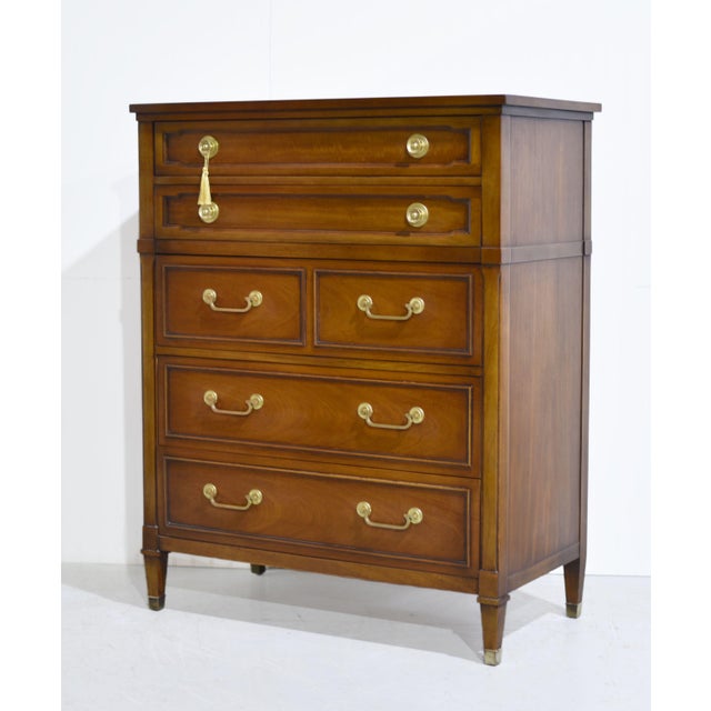 A mid century transitional 5-drawer highboy by Drexel, crafted in solid mahogany with a warm honey-brown finish. A pair of...