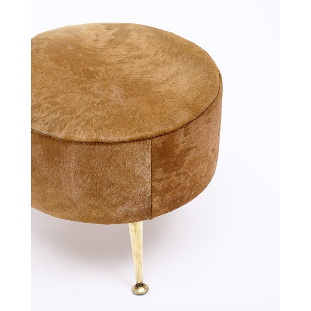 Single Italian period mid-century modern stool that has been newly upholstered in a tan cowhide. This piece is supported...