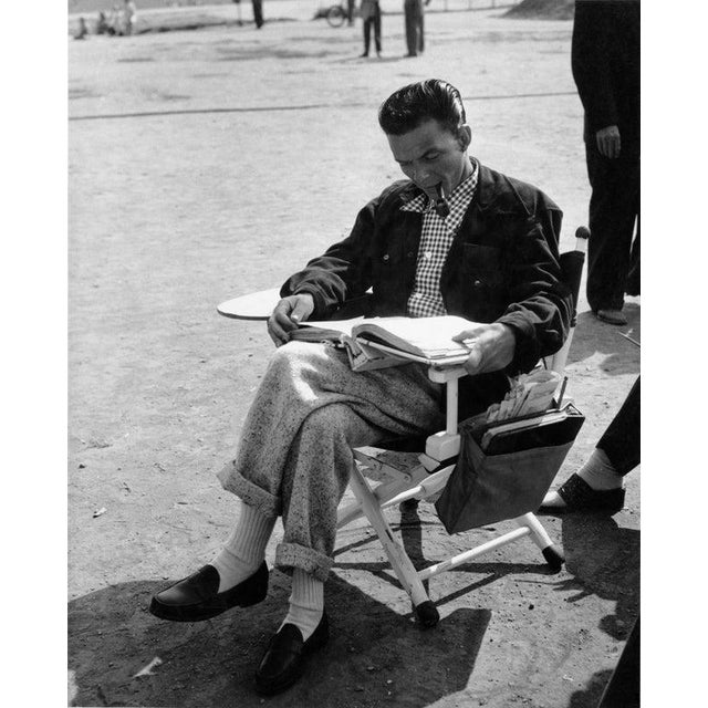 Frank Sinatra American actor and singer Frank Sinatra (1915 - 1998) studies the script between takes on the set of the...