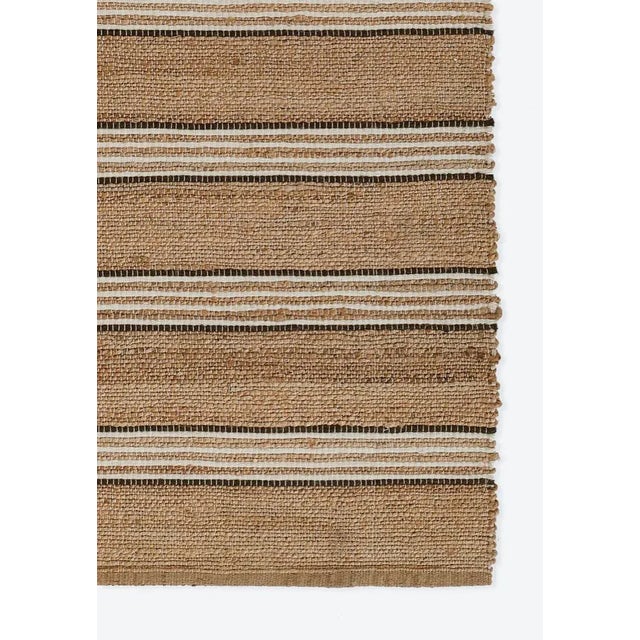 A different take on a simple stripe style, this tightly handwoven natural jute and wool rug is the modern marvel your...
