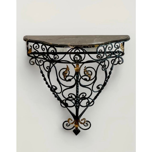 Vintage 1960s Rococo style wrought iron wall mount console table with a marble top, made in Italy. Stunning console having...