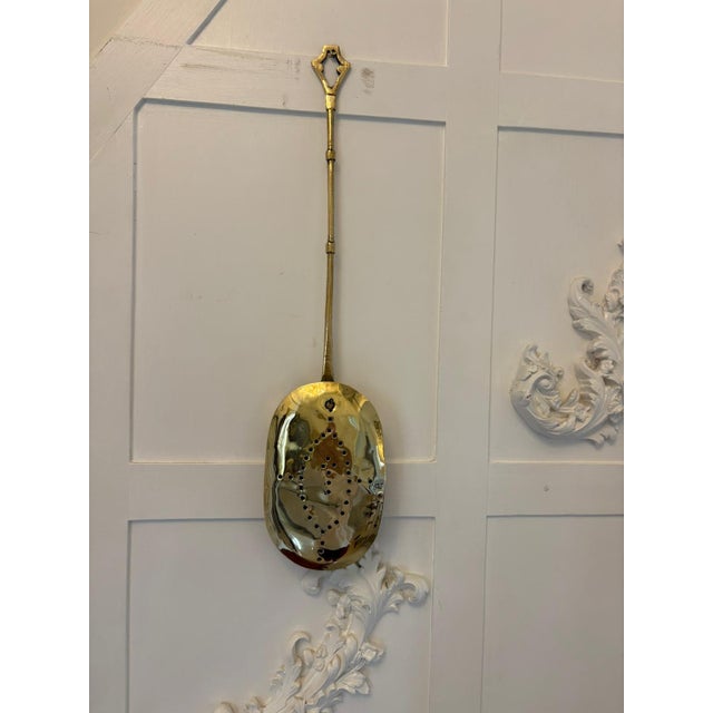 Antique Victorian brass chestnut roaster having a brass handle attached to an oval shaped chestnut roaster with a pieced...