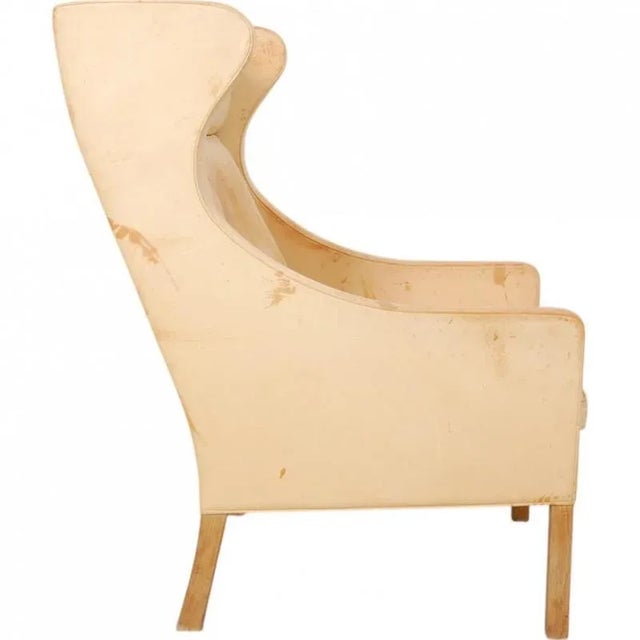 Børge Mogensen wingchair, model 2204, upholstered with original natural leather and with legs of oak. The chair is from...