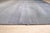 A 7' 9" x 9' 9" hand-knotted wool rug with a gray ombre that shades from charcoal to silver with hints of lilac, in a...
